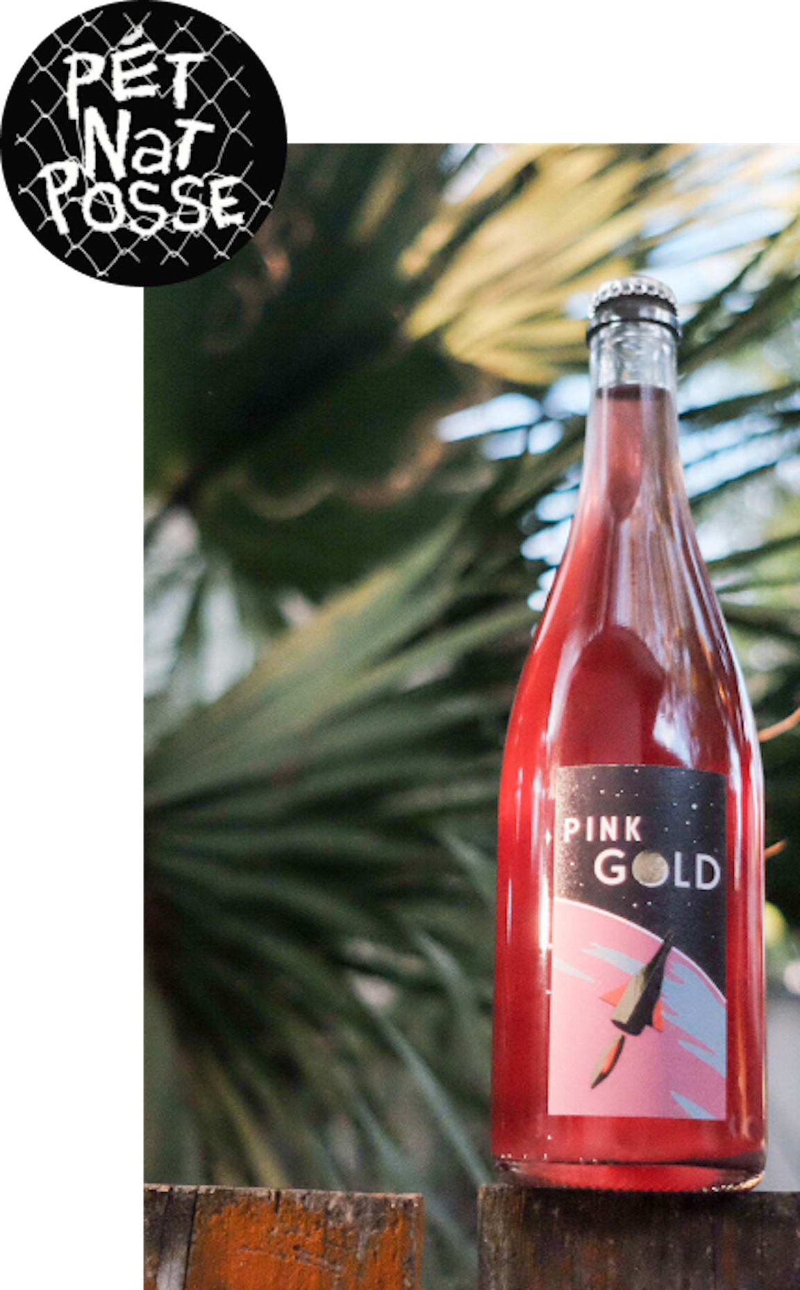 A bottle of pink-red wine with a label reading "Pink Gold."